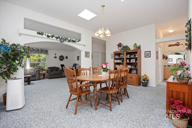 321 S 600 E, Jerome, ID 83338 - dining area with light carpet, arched walkways, and a chandelier