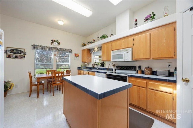321 S 600 E, Jerome, ID 83338 - kitchen with white appliances, a sink, a kitchen island, light floors, and tile counters