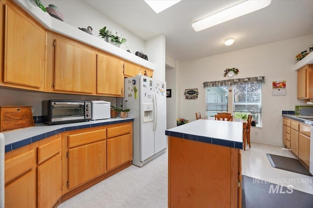 321 S 600 E, Jerome, ID 83338 - kitchen featuring white fridge with ice dispenser, light floors, a center island, and tile counters