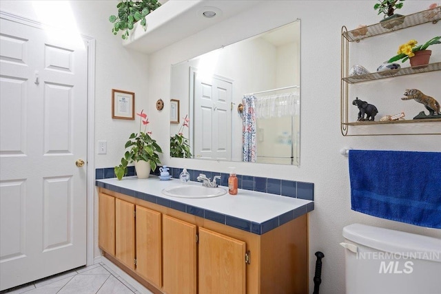 321 S 600 E, Jerome, ID 83338 - full bathroom featuring vanity, toilet, a shower with curtain, and tile patterned floors