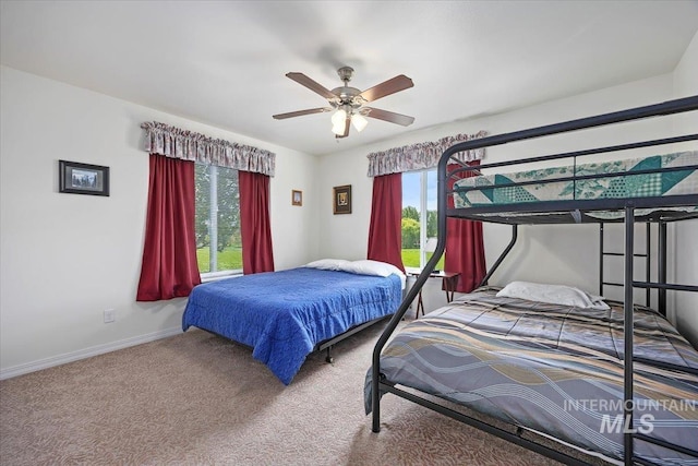 321 S 600 E, Jerome, ID 83338 - bedroom featuring multiple windows, carpet flooring, baseboards, and a ceiling fan