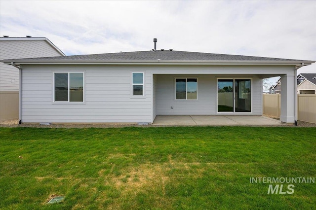 6312 W Pewter Point St, Meridian, ID 83646 - back of property with fence, a lawn, and a patio