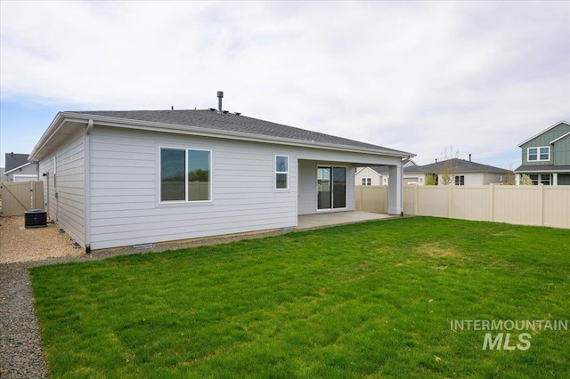 6312 W Pewter Point St, Meridian, ID 83646 - back of property featuring a patio, a yard, central AC, and fence