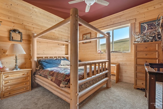 carpeted bedroom with wooden walls