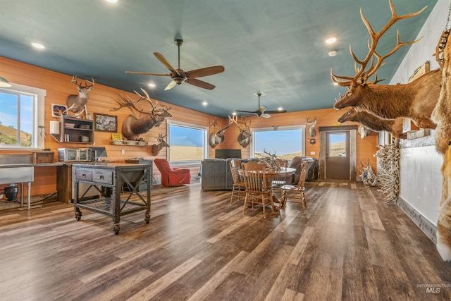 dining area with wooden walls, wood finished floors, recessed lighting, and ceiling fan
