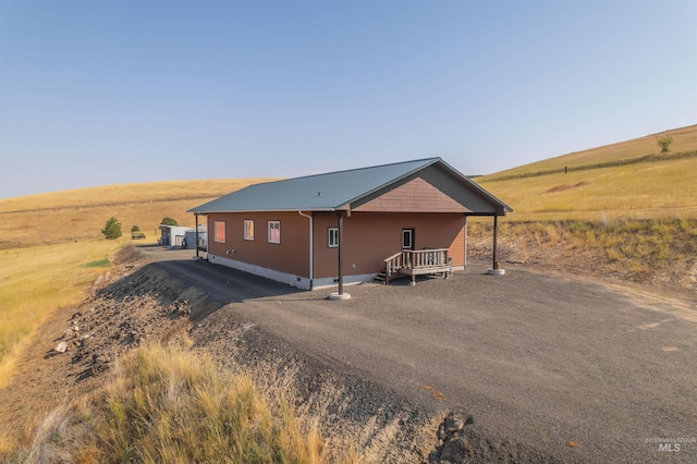 view of home's exterior with crawl space and a rural view