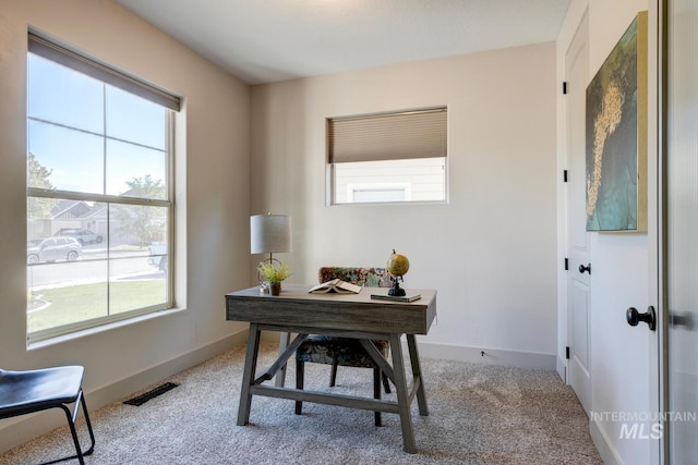 home office with baseboards, visible vents, and carpet floors