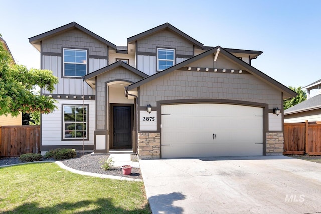 view of front of home featuring a garage, stone siding, and fence