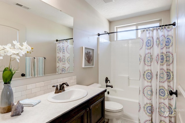 full bathroom with vanity, visible vents, shower / bath combination with curtain, a textured ceiling, and toilet