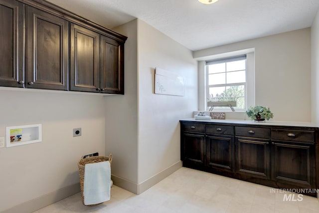 laundry area featuring cabinet space, hookup for an electric dryer, hookup for a washing machine, and baseboards