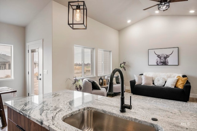 1100 Tanglewood St, Burley, ID 83318 - kitchen featuring open floor plan, a sink, light stone countertops, and ceiling fan
