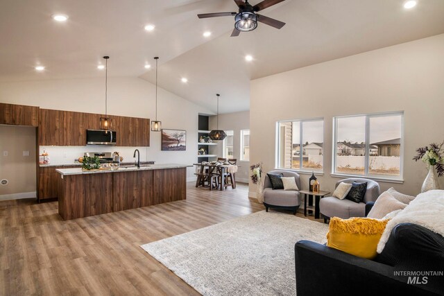 1100 Tanglewood St, Burley, ID 83318 - living area with recessed lighting, light wood-type flooring, high vaulted ceiling, baseboards, and ceiling fan