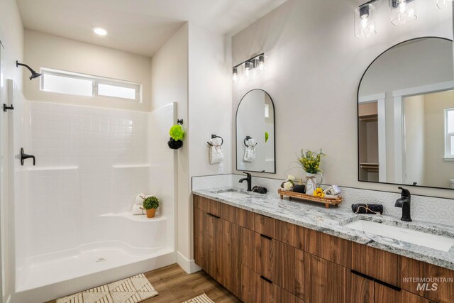 1100 Tanglewood St, Burley, ID 83318 - bathroom featuring a sink, a shower, and wood finished floors