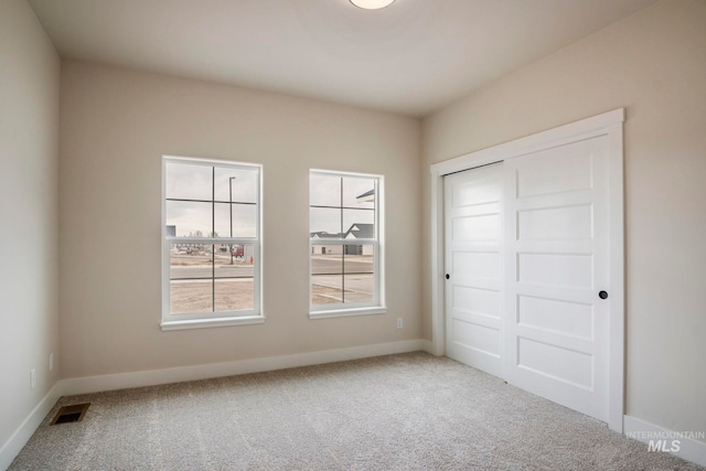 1100 Tanglewood St, Burley, ID 83318 - unfurnished bedroom featuring a closet, baseboards, visible vents, and carpet