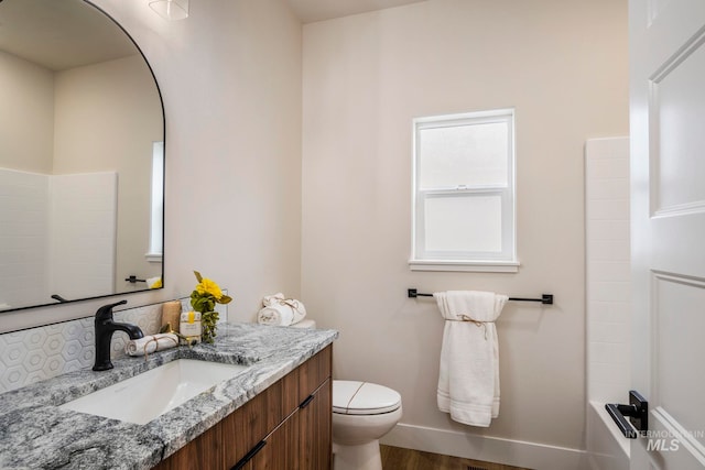 1100 Tanglewood St, Burley, ID 83318 - full bathroom featuring baseboards, wood finished floors, toilet, and vanity