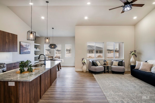 1100 Tanglewood St, Burley, ID 83318 - interior space featuring light wood finished floors, modern cabinets, a ceiling fan, a sink, and a spacious island