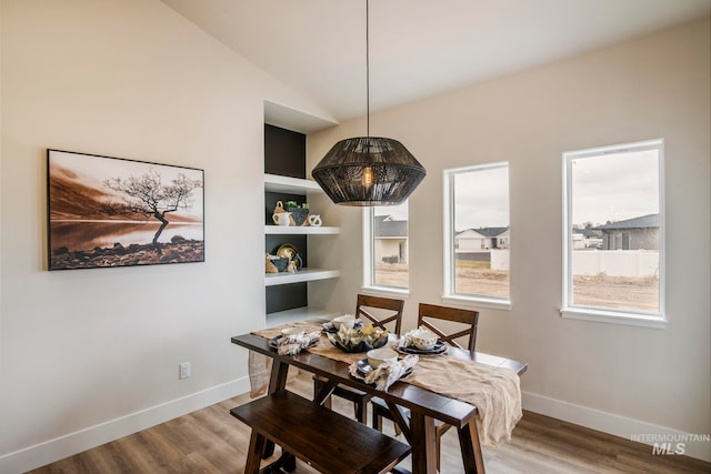 1100 Tanglewood St, Burley, ID 83318 - dining space with baseboards, wood finished floors, and vaulted ceiling