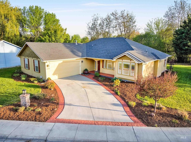 ranch-style home featuring a garage, concrete driveway, a front lawn, and roof with shingles