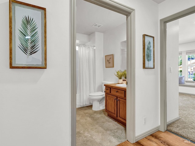 full bathroom with vanity, toilet, baseboards, and curtained shower