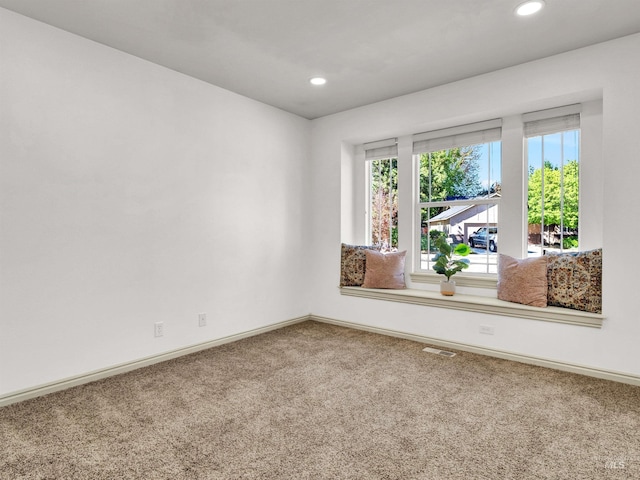 empty room with carpet floors, baseboards, and recessed lighting