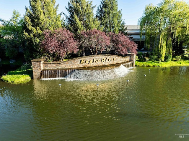 community / neighborhood sign featuring a water view
