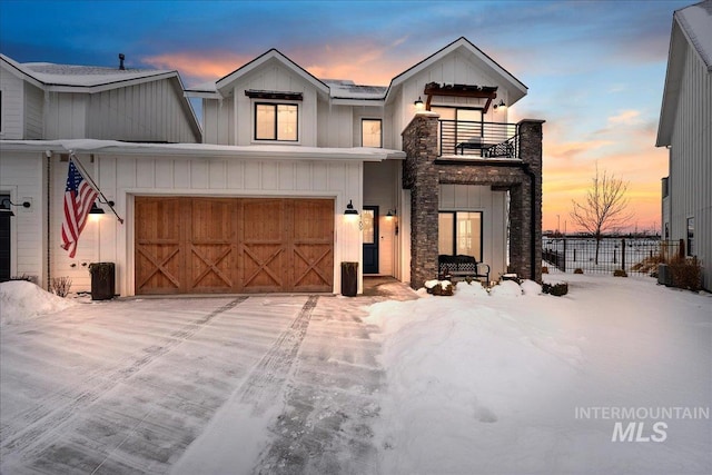 view of front of home featuring a garage and a balcony