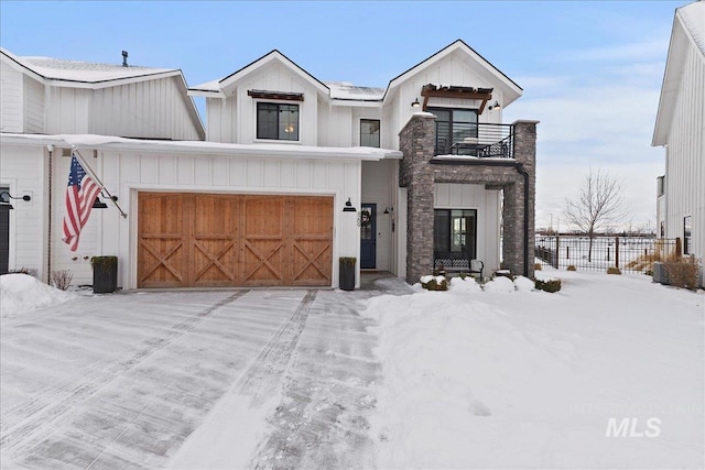 view of front of house with a garage and a balcony