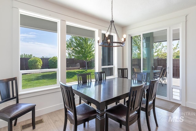 3713 W Ladle Rapids St, Meridian, ID 83646 - dining room featuring an inviting chandelier, light wood-type flooring, visible vents, and baseboards