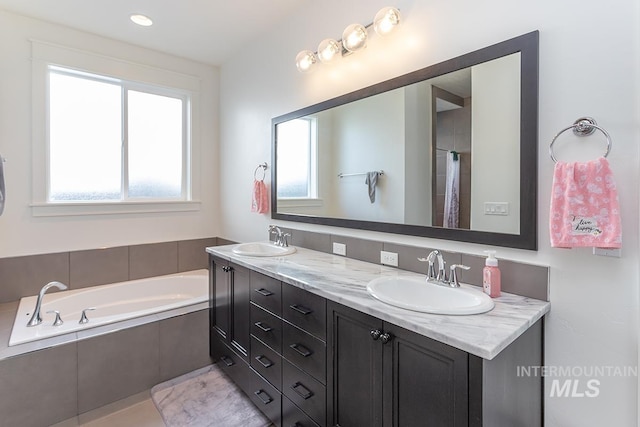 3713 W Ladle Rapids St, Meridian, ID 83646 - bathroom with double vanity, a garden tub, and a sink