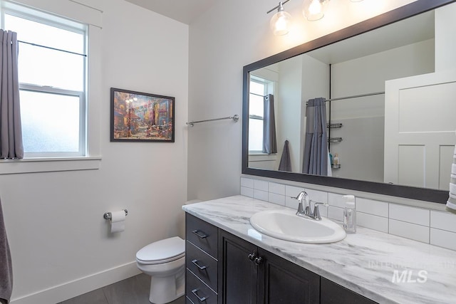 3713 W Ladle Rapids St, Meridian, ID 83646 - bathroom featuring baseboards, toilet, curtained shower, vanity, and backsplash