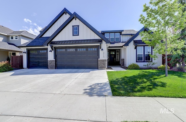3713 W Ladle Rapids St, Meridian, ID 83646 - view of front of home with board and batten siding, a standing seam roof, an attached garage, concrete driveway, and a front lawn