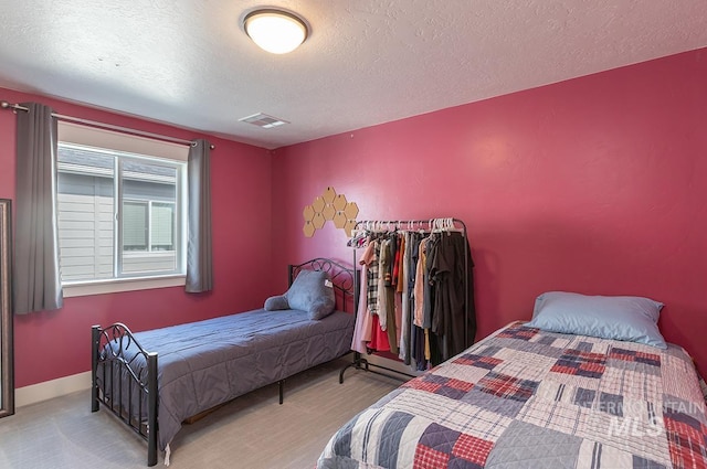 3713 W Ladle Rapids St, Meridian, ID 83646 - bedroom featuring baseboards, visible vents, and a textured ceiling