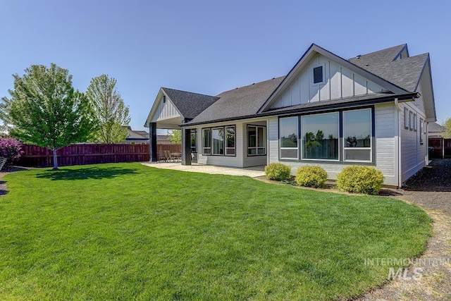 3713 W Ladle Rapids St, Meridian, ID 83646 - rear view of property featuring a yard, board and batten siding, fence, a patio, and a shingled roof