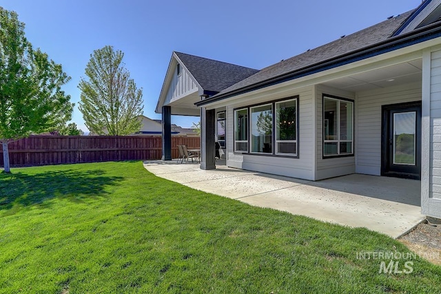 3713 W Ladle Rapids St, Meridian, ID 83646 - back of property with a yard, a patio area, roof with shingles, and fence