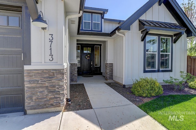 3713 W Ladle Rapids St, Meridian, ID 83646 - doorway to property with board and batten siding, stone siding, and fence
