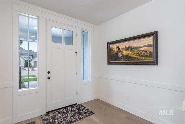 3713 W Ladle Rapids St, Meridian, ID 83646 - foyer with wood finished floors, wainscoting, and a healthy amount of sunlight