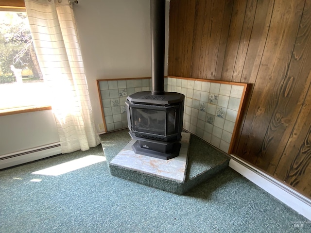 room details with wooden walls, carpet, and a wood stove