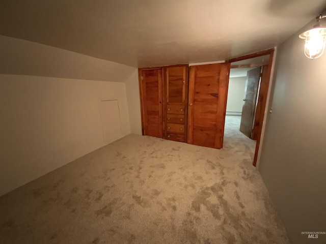 bonus room with vaulted ceiling, light carpet, and baseboard heating