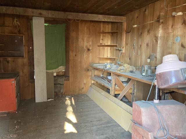 miscellaneous room featuring a workshop area, wooden ceiling, and wood walls