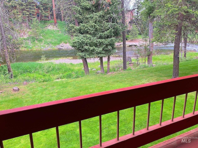 view of yard with a water view and a balcony