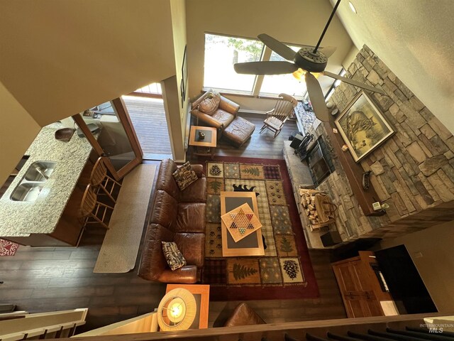living area featuring a ceiling fan and hardwood / wood-style floors