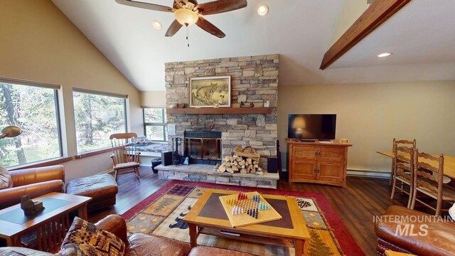 living area with wood finished floors, a stone fireplace, ceiling fan, high vaulted ceiling, and a baseboard radiator
