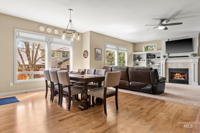 1215 N Macaile, Eagle, ID 83616 - dining area with a fireplace, ceiling fan, light wood-style floors, and baseboards