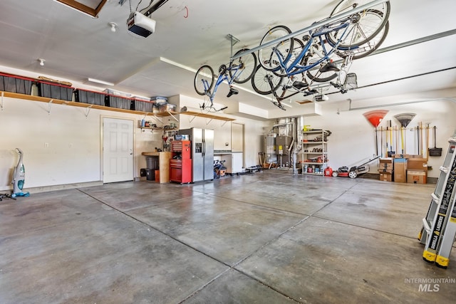1215 N Macaile, Eagle, ID 83616 - garage featuring stainless steel refrigerator with ice dispenser, a garage door opener, and water heater