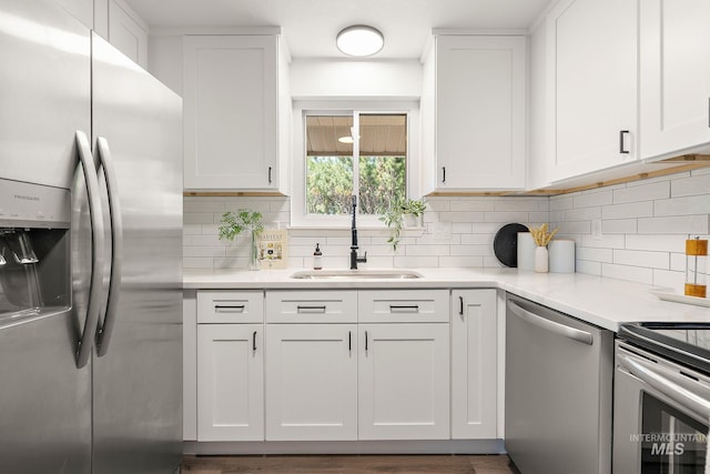 64 Borah, Nampa, ID 83651 - kitchen featuring appliances with stainless steel finishes, a sink, white cabinets, and tasteful backsplash