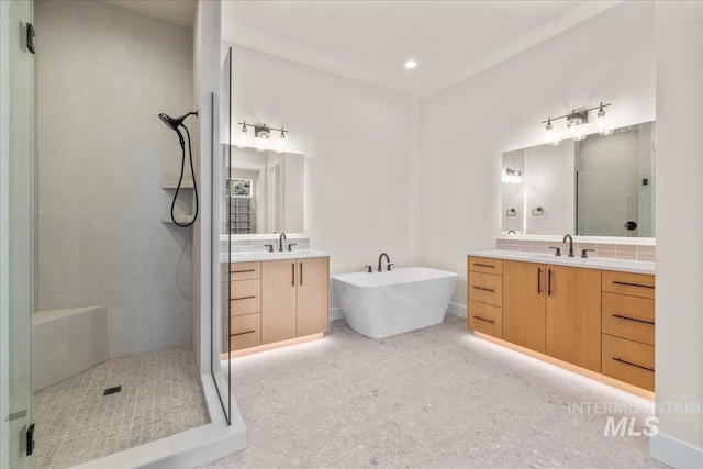 bathroom featuring vanity and shower with separate bathtub