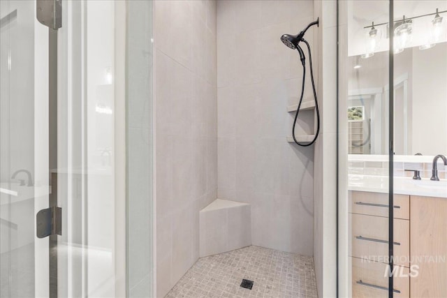 bathroom featuring vanity and a shower with door