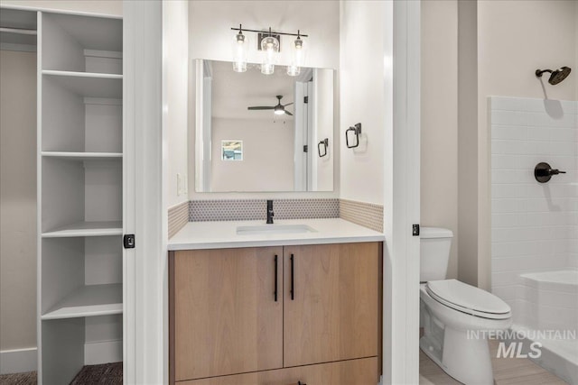 bathroom with ceiling fan, a shower, toilet, and vanity