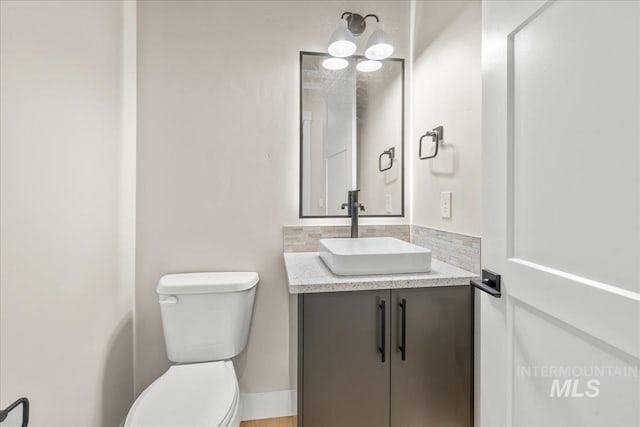 bathroom featuring toilet and vanity