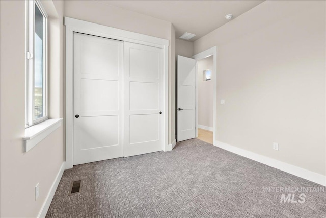 unfurnished bedroom featuring a closet and carpet